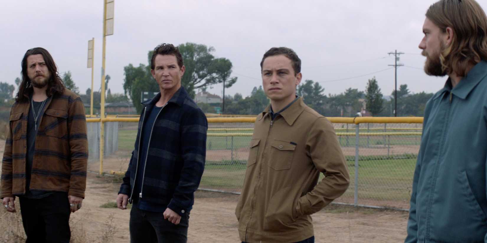 Ben Robson, Shawn Hatosy, Finn Cole, Jake Weary standing next to a baseball field in Animal Kingdom