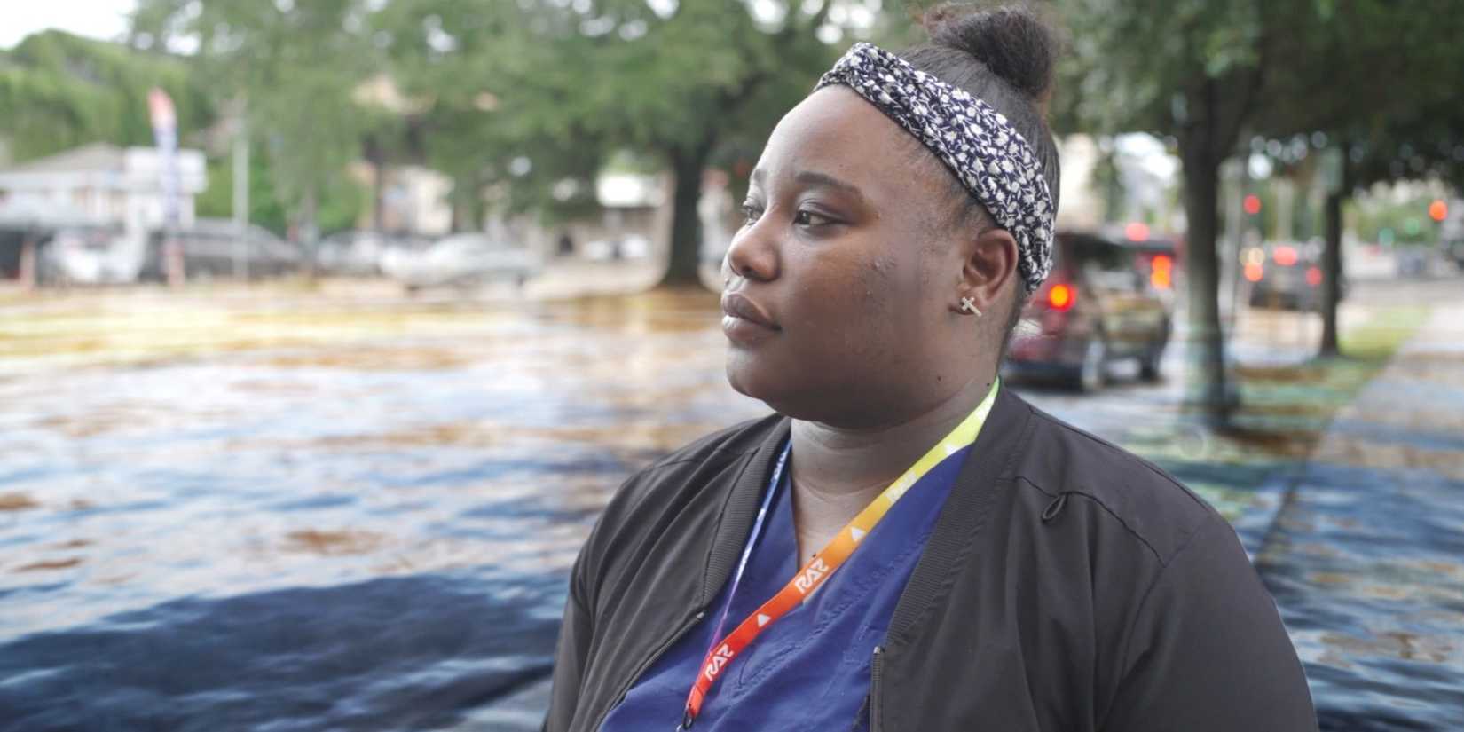 Leann Williams standing by a flooded area in Katrina: Come Hell and High Water