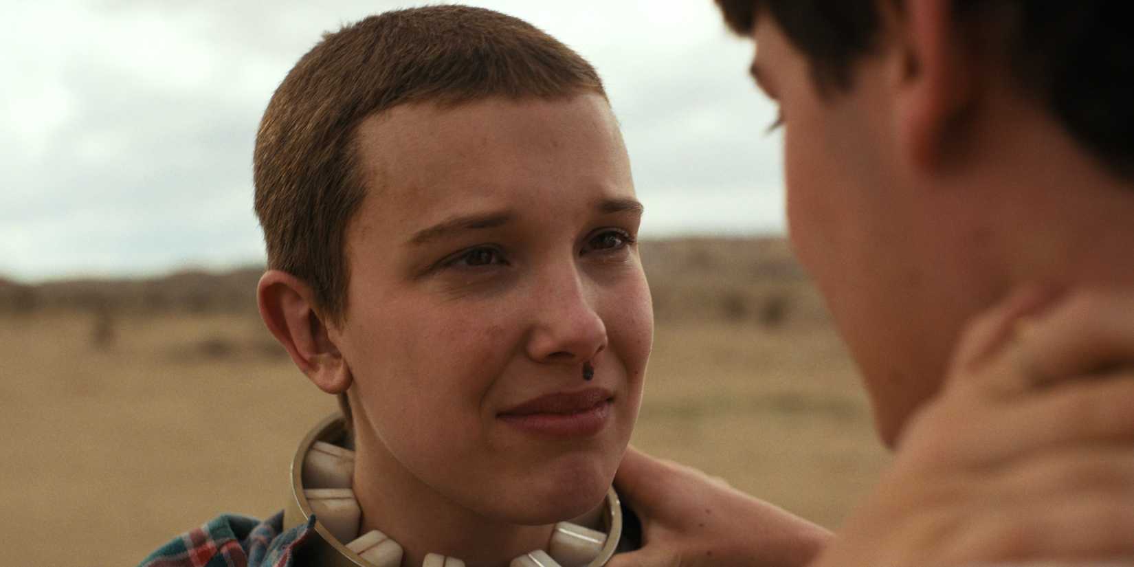 Eleven (Millie Bobby Brown), looking gratefully at Will Byers (Noah Schnapp) in Stranger Things season 4, "Chapter Eight: Papa"