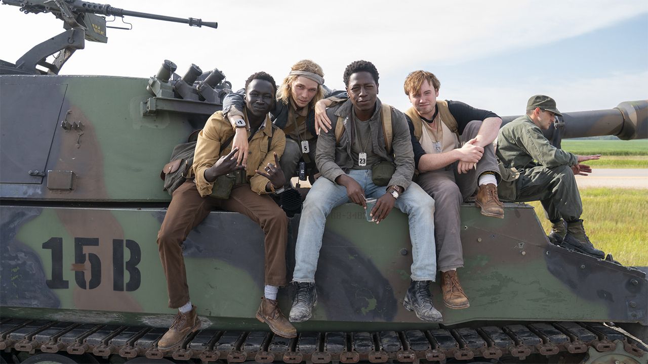 The Long Walk cast in front of a tank