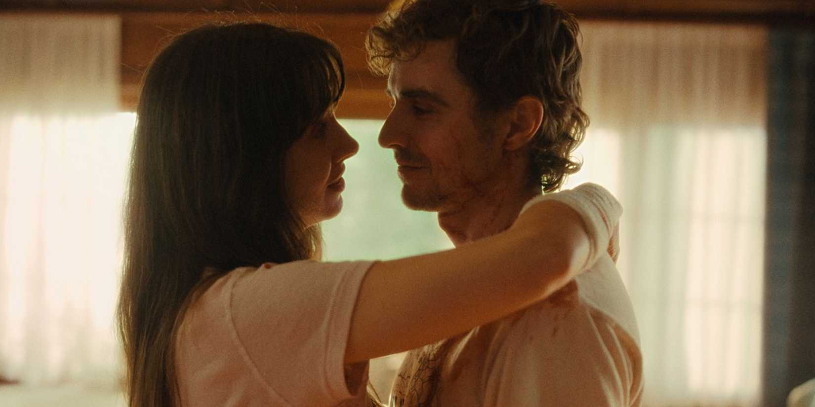 Alison Brie and Dave Franco standing close together, with her arm around his shoulder, in Together