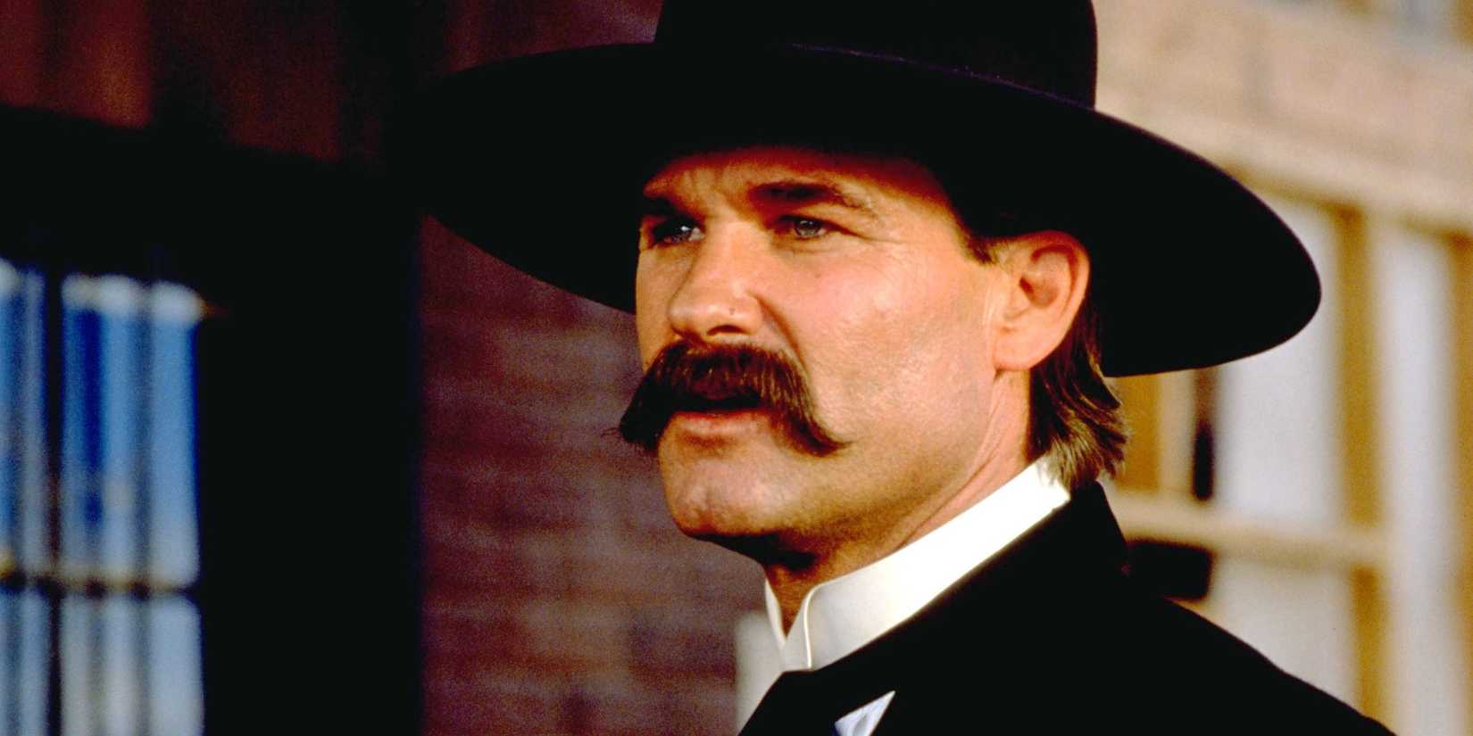 Kurt Russell looks on with an angry expression in Tombstone