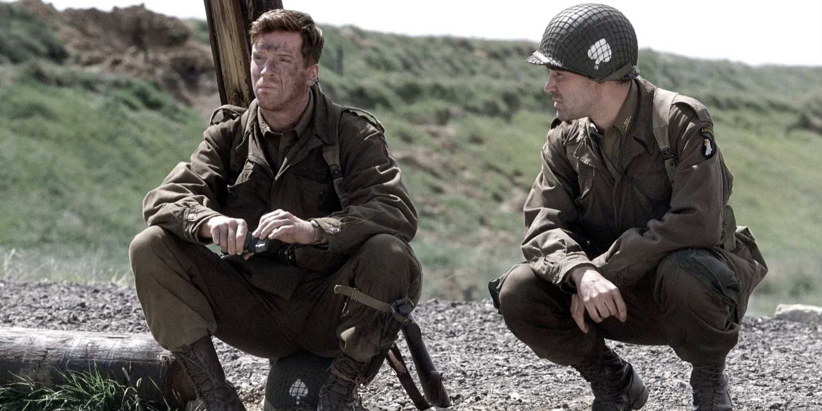 Two_soldiers_crouch_down_in_the_mud_in_Band_of_Brothers