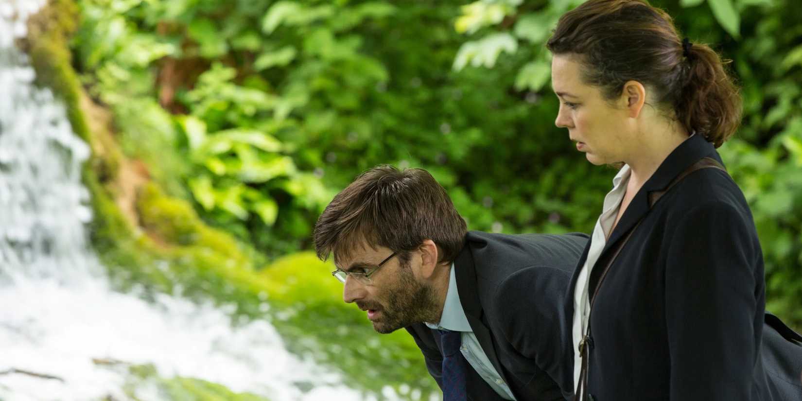 David Tennant as Alec Hardy and Olivia Colman as Ellie Miller standing in a woodland in Broadchurch