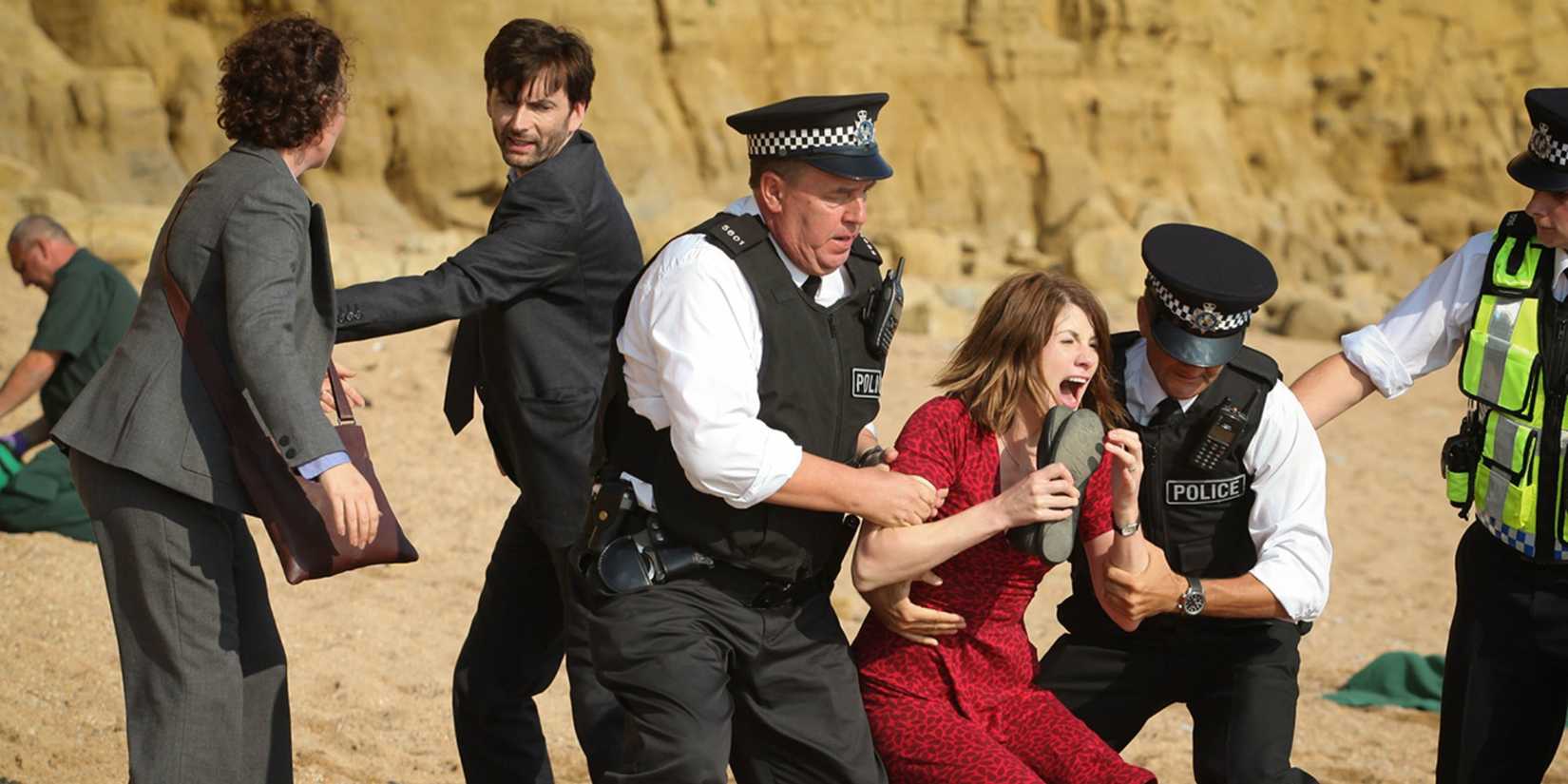 The police trying to calm Beth down on the beach as Ellie and Alec help nearby in Broadchurch.