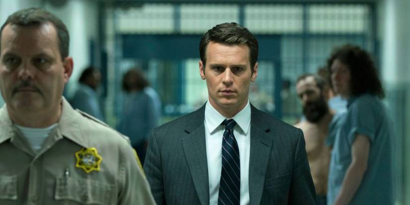 Holden Ford (Jonathan Groff) walking in a prison on Mindhunter