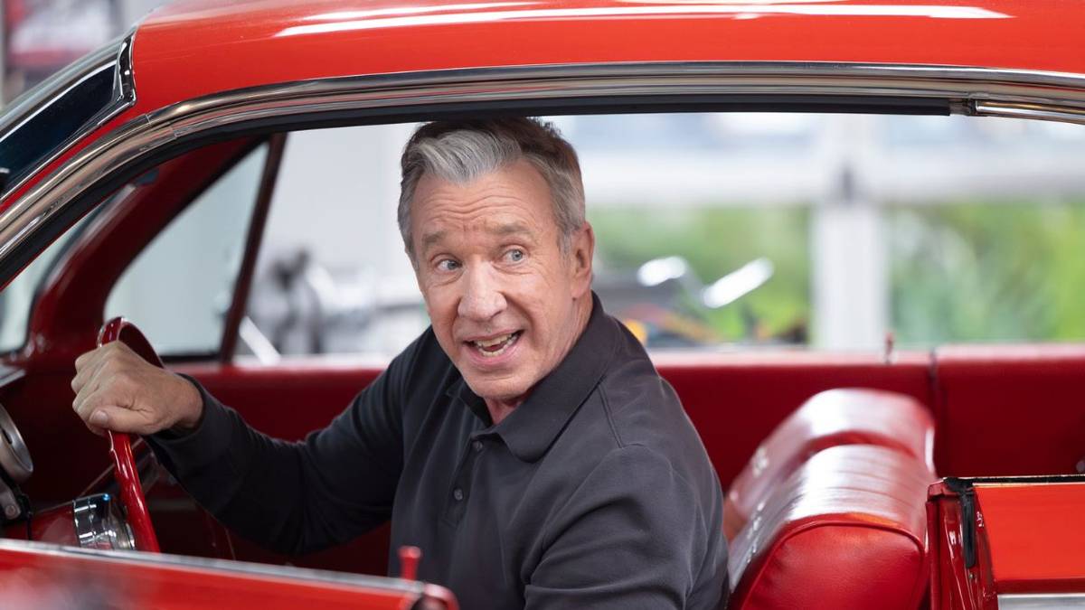 Tim Allen reversing in a red car
