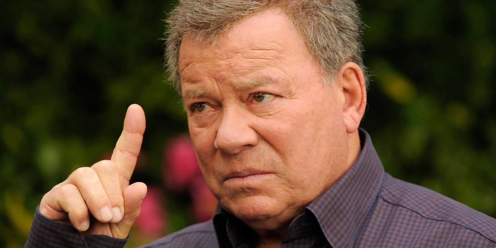 William Shatner is raising his finger up in a movie
