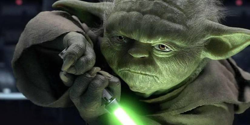 yoda wielding a lightsaber in star wars