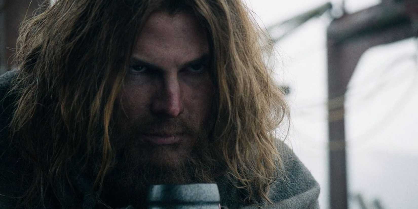 A grizzled, bearded Stephen Amell as Oliver Queen staring menacingly in the Arrow pilot episode