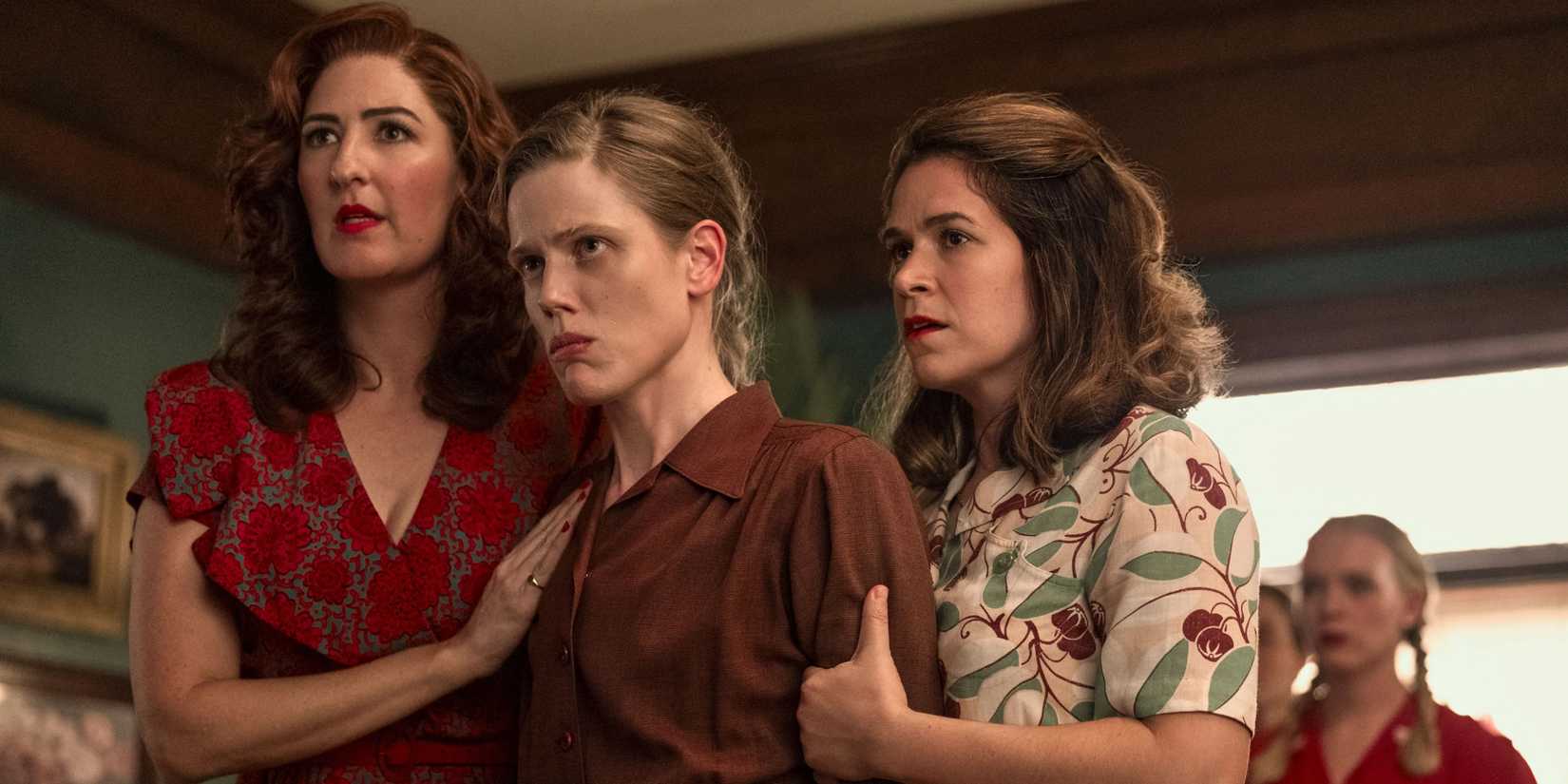 A League of Their Own characters holding each other in support