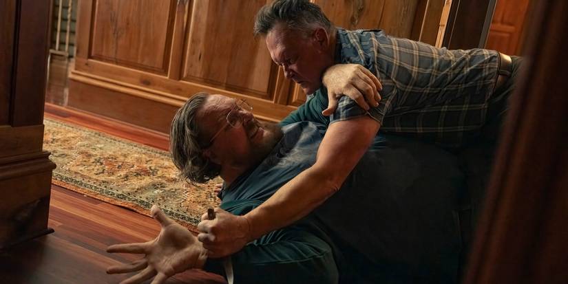 Auggie Smith about to stab John Economos in Peacemaker season 2