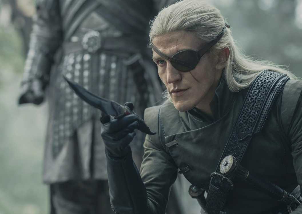Aemond Targaryen (Ewan Mitchell) kneeling with a knife in House of the Dragon
