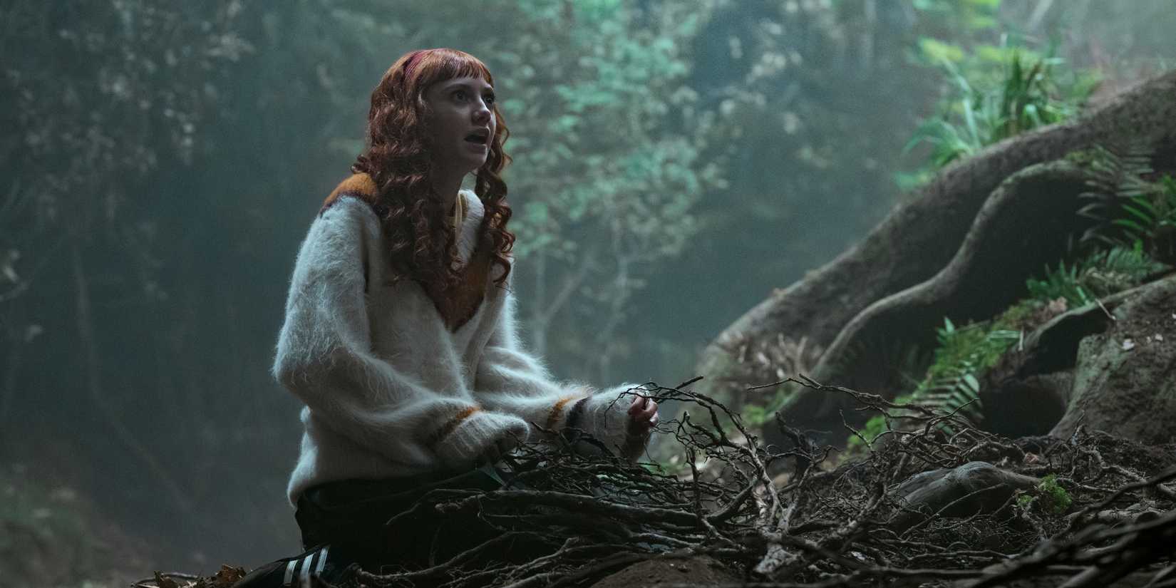Agnes in Wednesday season 2 episode 8 sittong on the ground in the forest