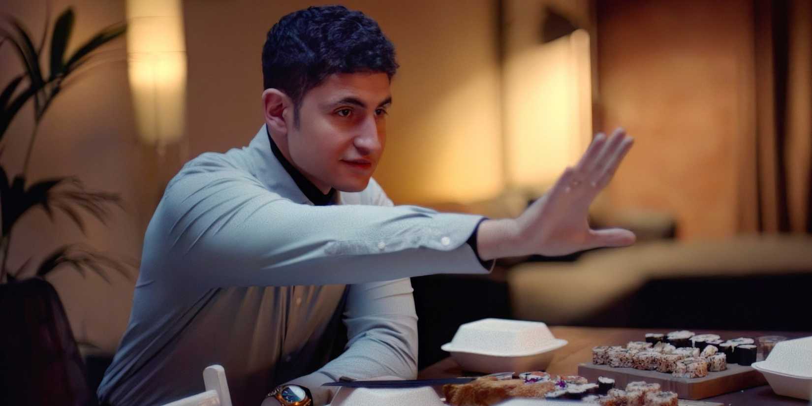 Amir El-Masry holding his hand up from In Camera
