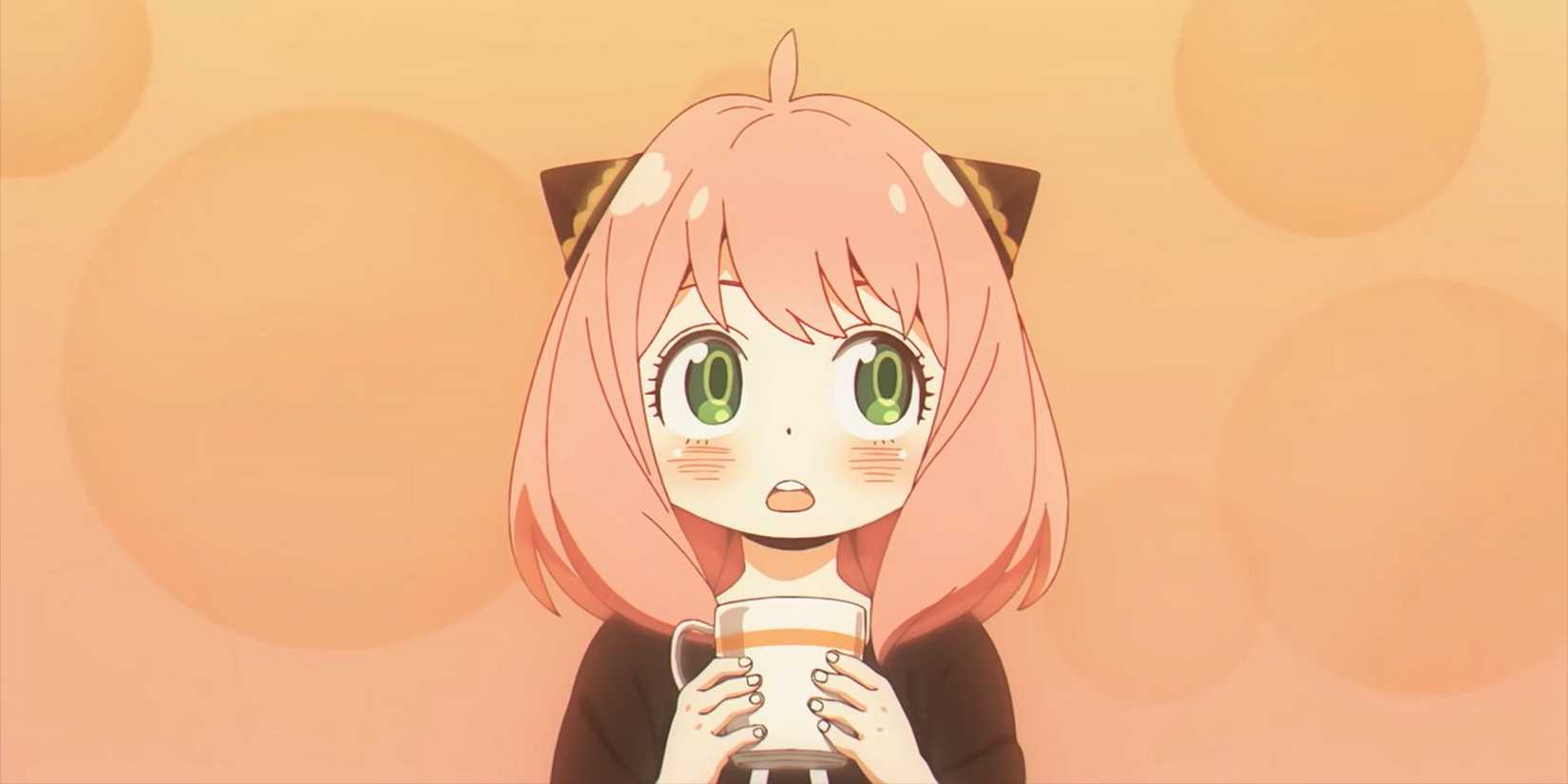 Anya Forger holding a mug against an orange background in Spy x Family.