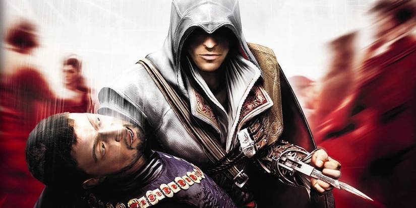 Assassin's Creed 2 Discovery box art, showing Ezio with his hidden blade out and holding an assassination target.