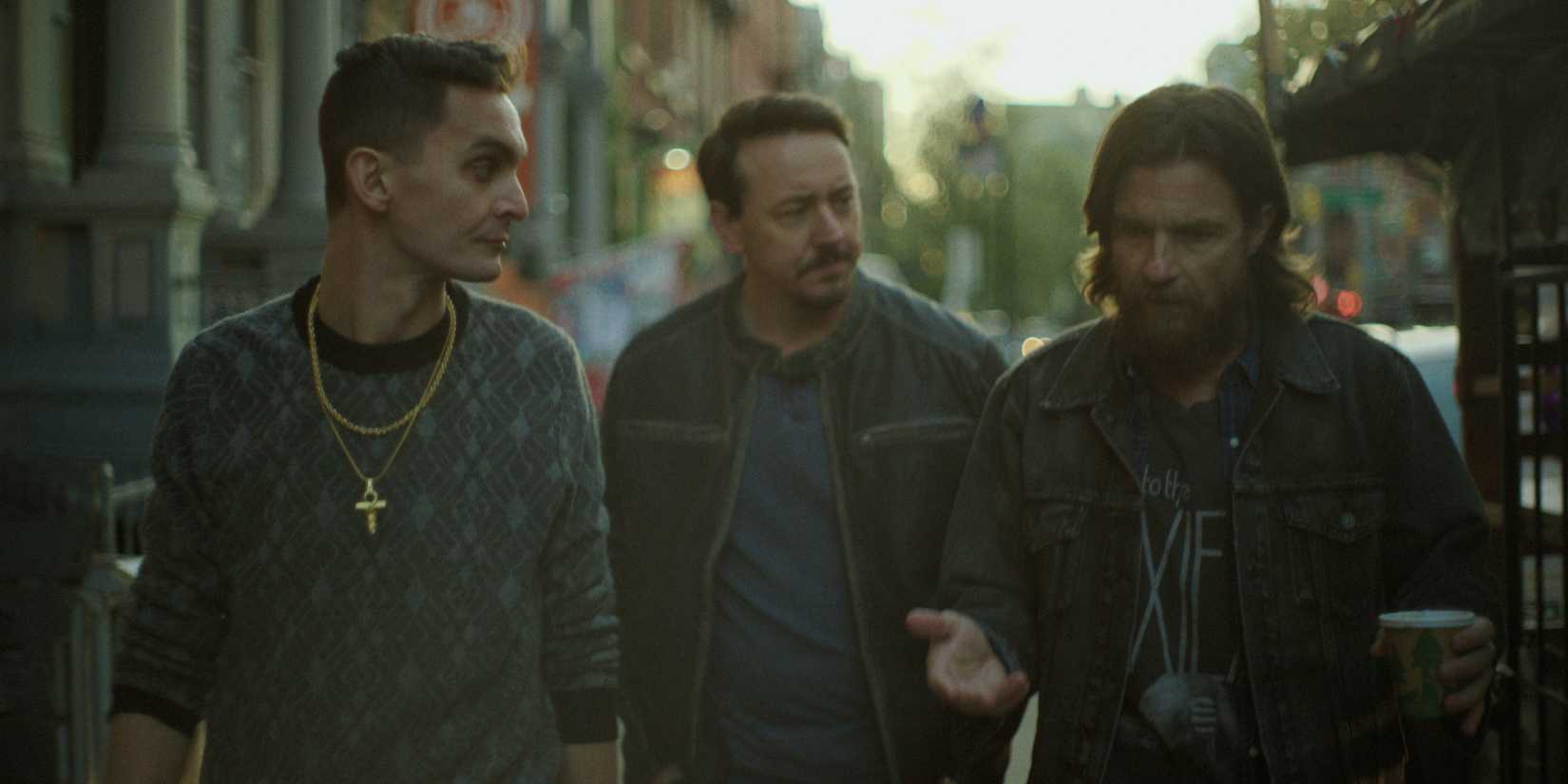 Junior, Babbit, and Vince walk down the street in Black Rabbit.