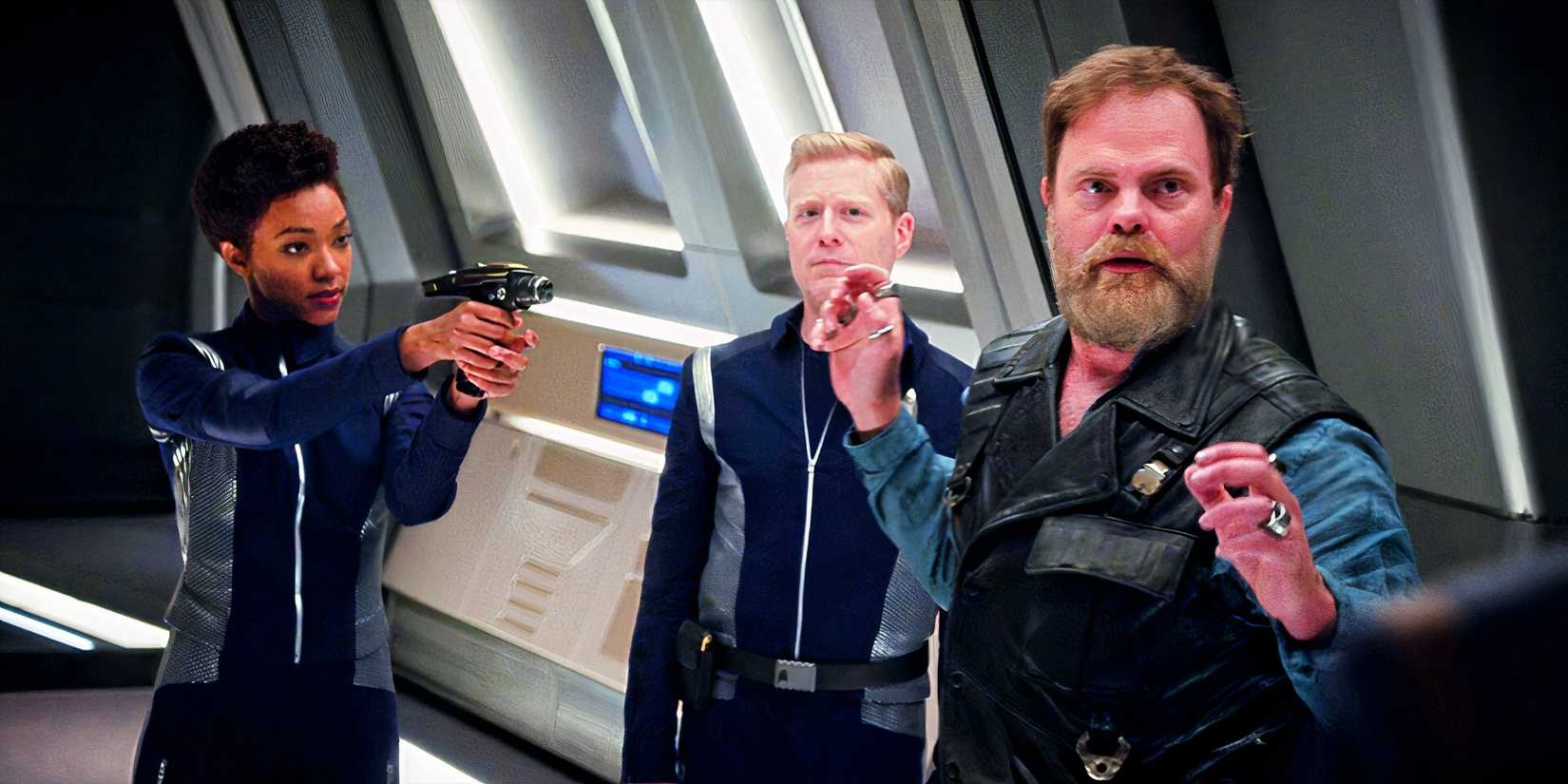 Burnham and Stamets pointing a phaser at Harry Mudd in Star Trek Discovery