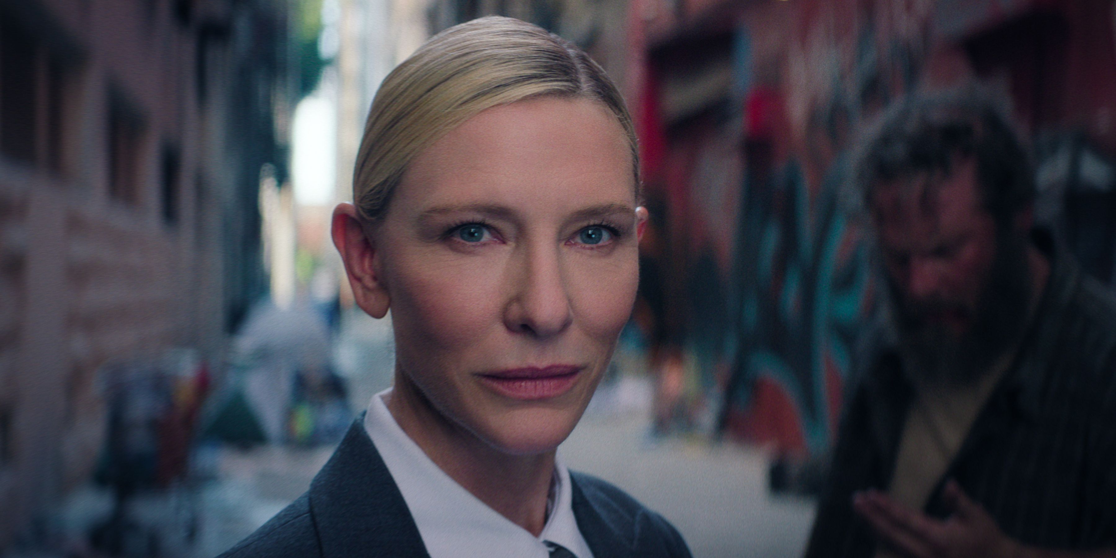 Cate Blanchett as the Recruiter and a homeless person in the background