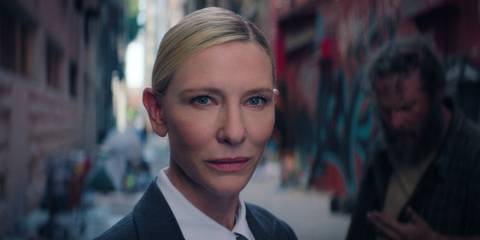 Cate Blanchett as the Recruiter and a homeless person in the background
