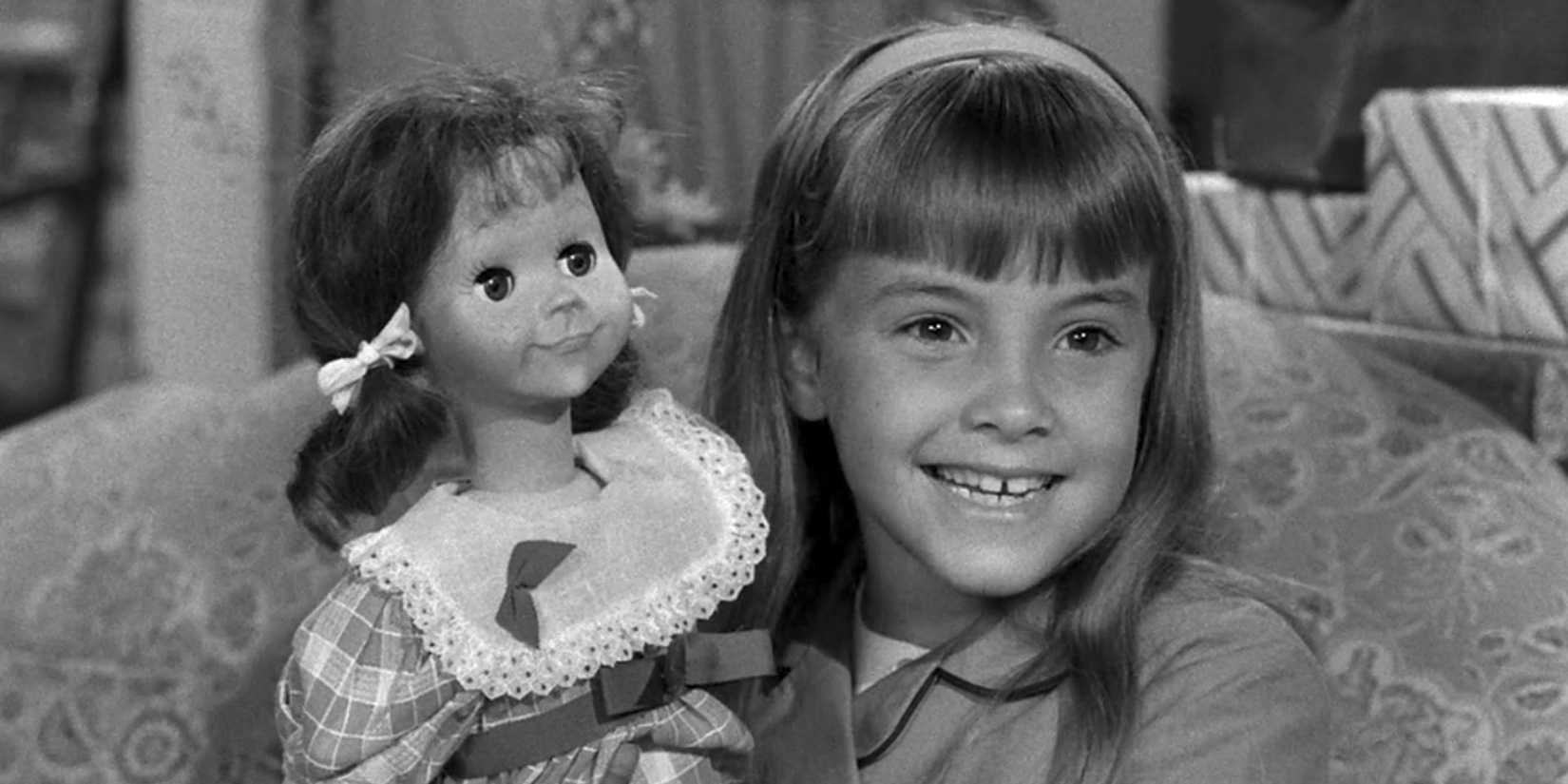 Christie happily showing Talky Tina in The Twilight Zone's Living Doll