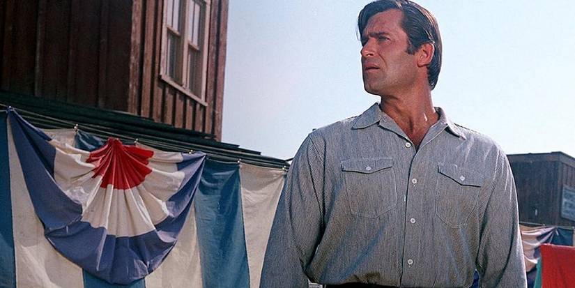Clint Walker stands cautiously in More ᴅᴇᴀᴅ Than Alive-1