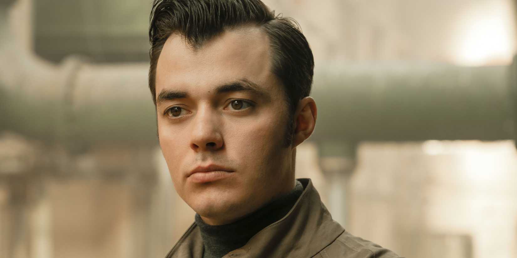 Close-up of Jack Bannon as Alfred Pennyworth looking stoic in the Pennyworth show