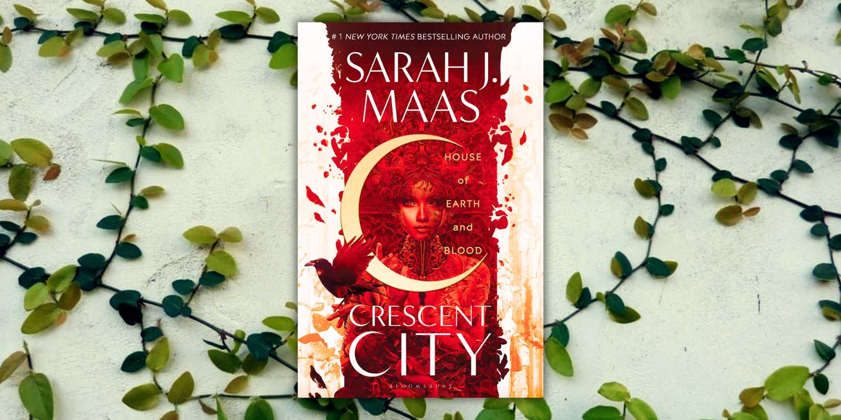 The cover of the book Crescent City over a wall of vines