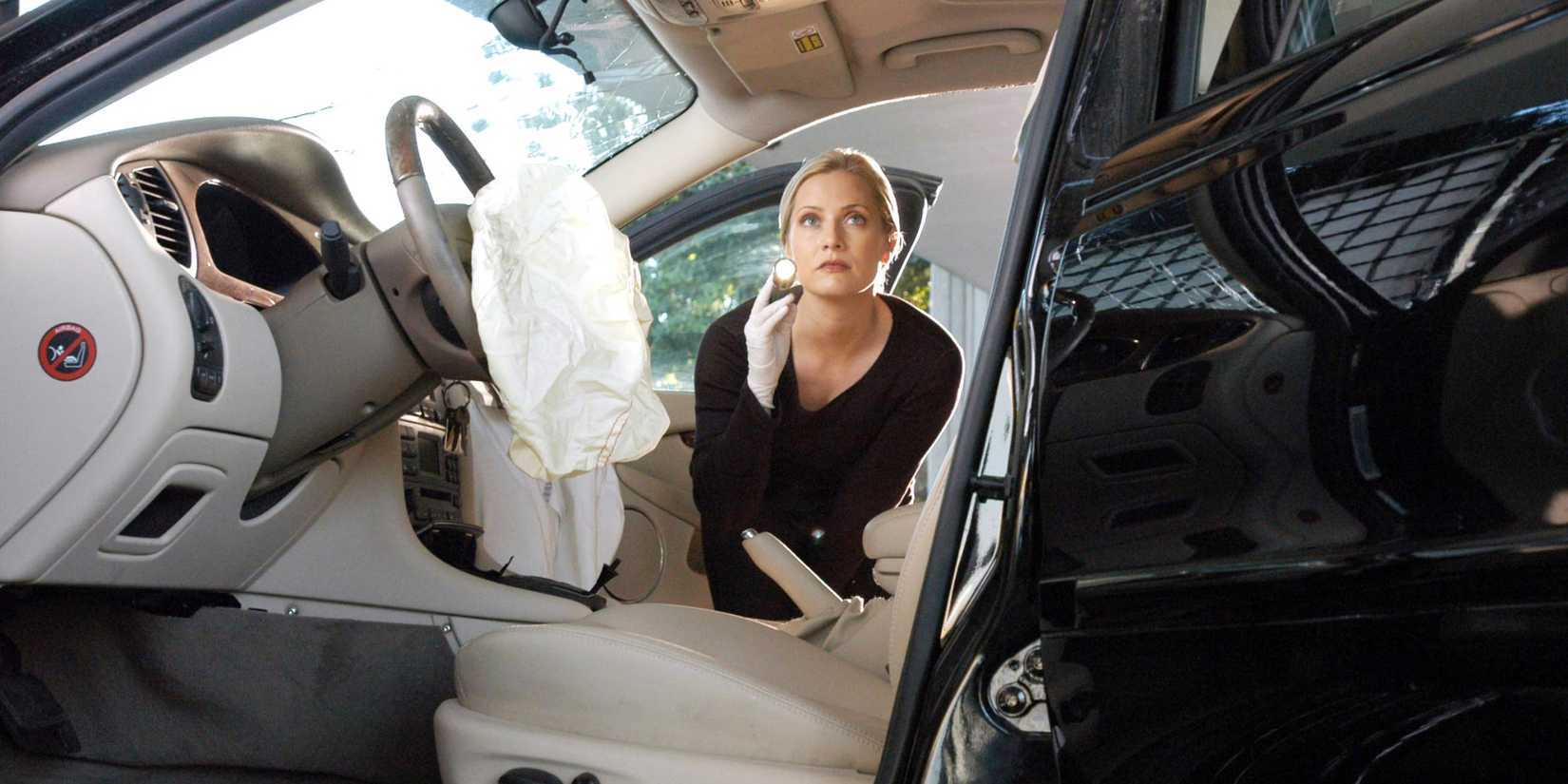 Calleigh (Emily Procter) examining a car after an airbag deployed in CSI: Miami