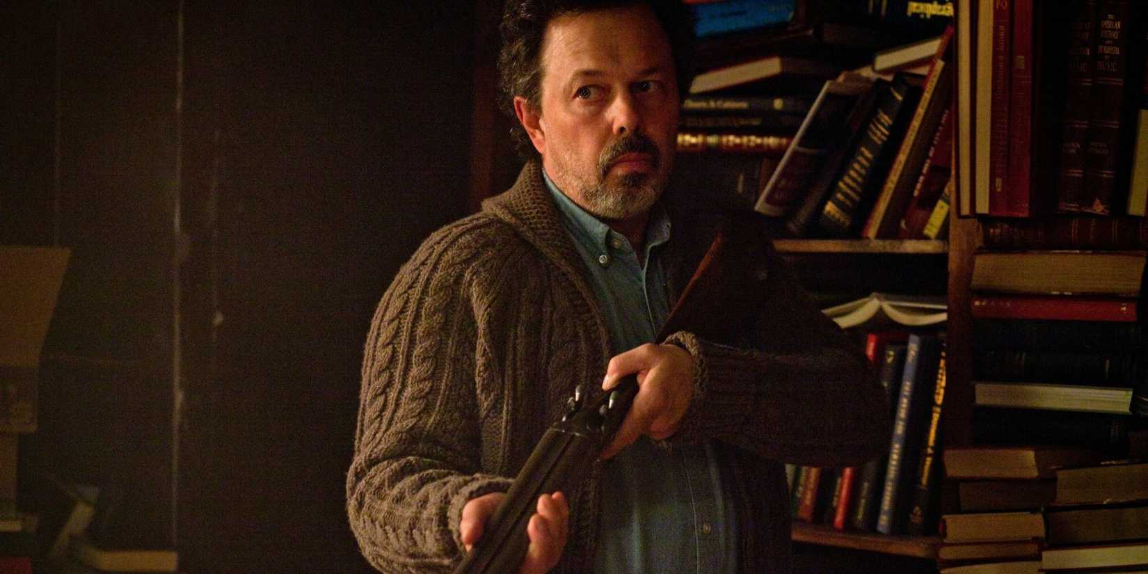 Curtis Armstrong as Metatron wielding a shotgun in Supernatural