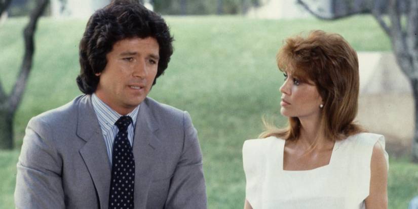 Victoria Principal and Patrick Duffy in Dallas standing outside looking serious