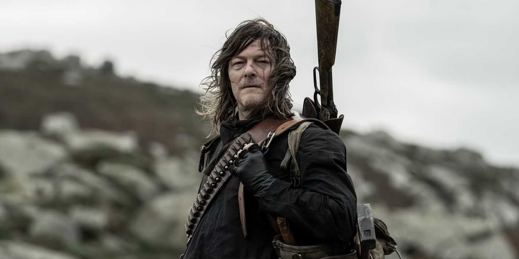 Norman Reedus as Daryl Dixon with a gun on his back standing on a mountain in The Walking Dead: Daryl Dixon season 3