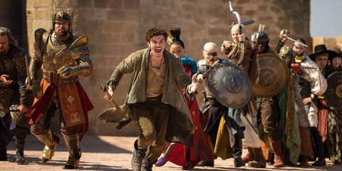 Donal Finn as Mat, center of image, running toward battle as other warriors follow behind him, in The Wheel of Time Battle of Falthe