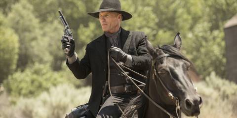 The Man in Black (Ed Harris) riding a horse and toting a revolver in Westworld