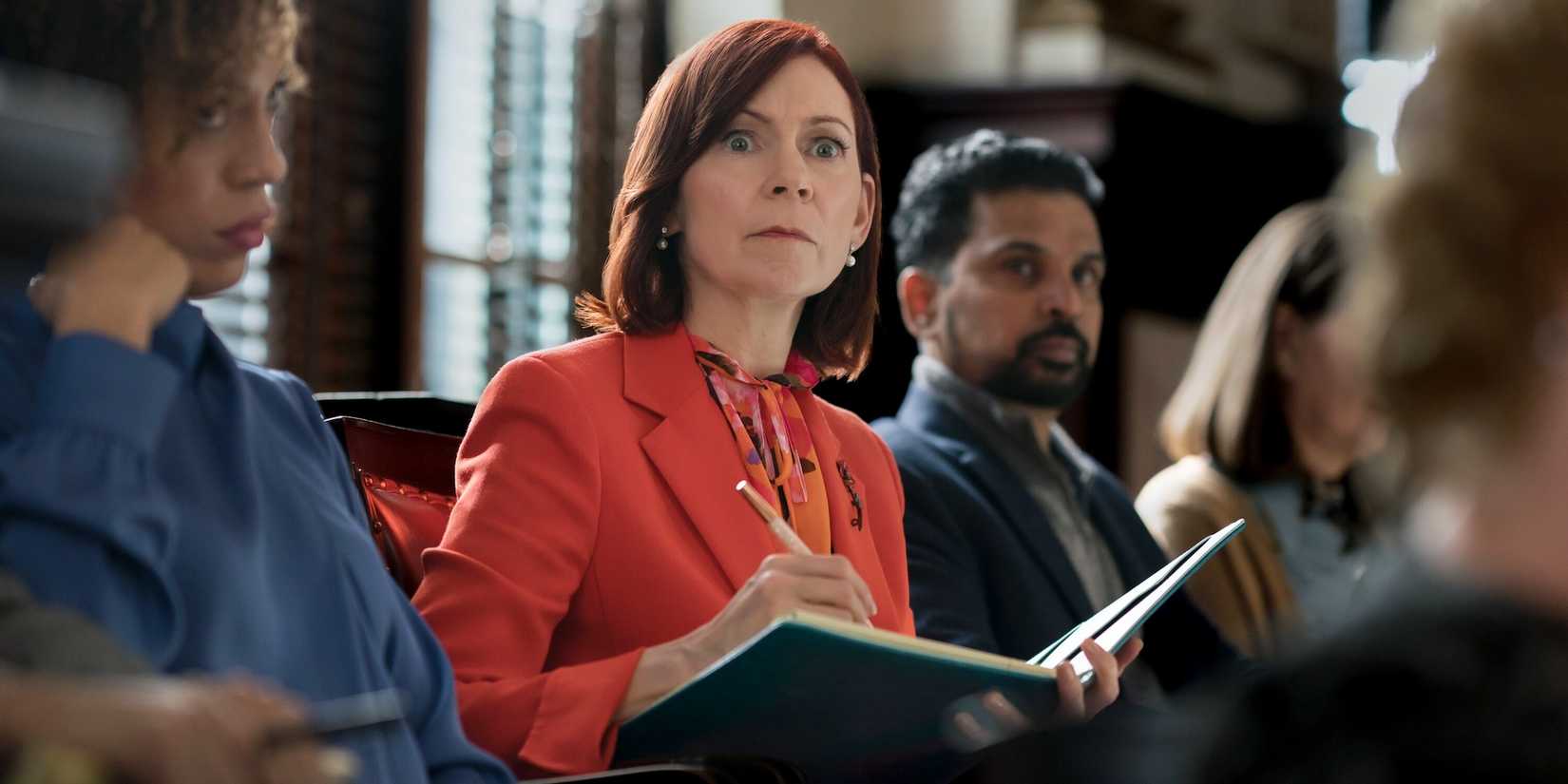 elsbeth takes notes while sitting on a jury