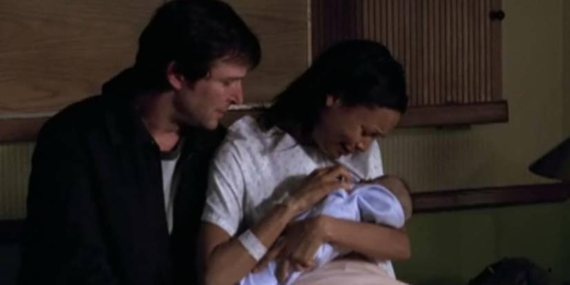 Carter (Noah Wyle) and Kem (Thandiwe Newton) with their baby on ER