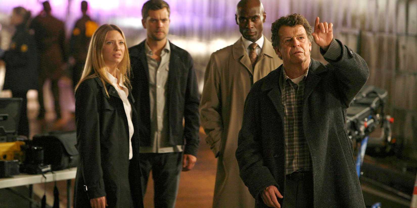 From left to right, the Fringe lead cast Anna Torv as Olivia Dunham, Joshua Jackson as Peter Bishop, Lance Reddick as Phillip Broyles, and John Noble as Walter Bishop