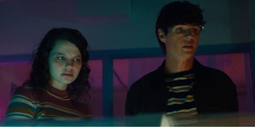 Gemma and Noah looking down at someone in a sleep chamber in Somnium