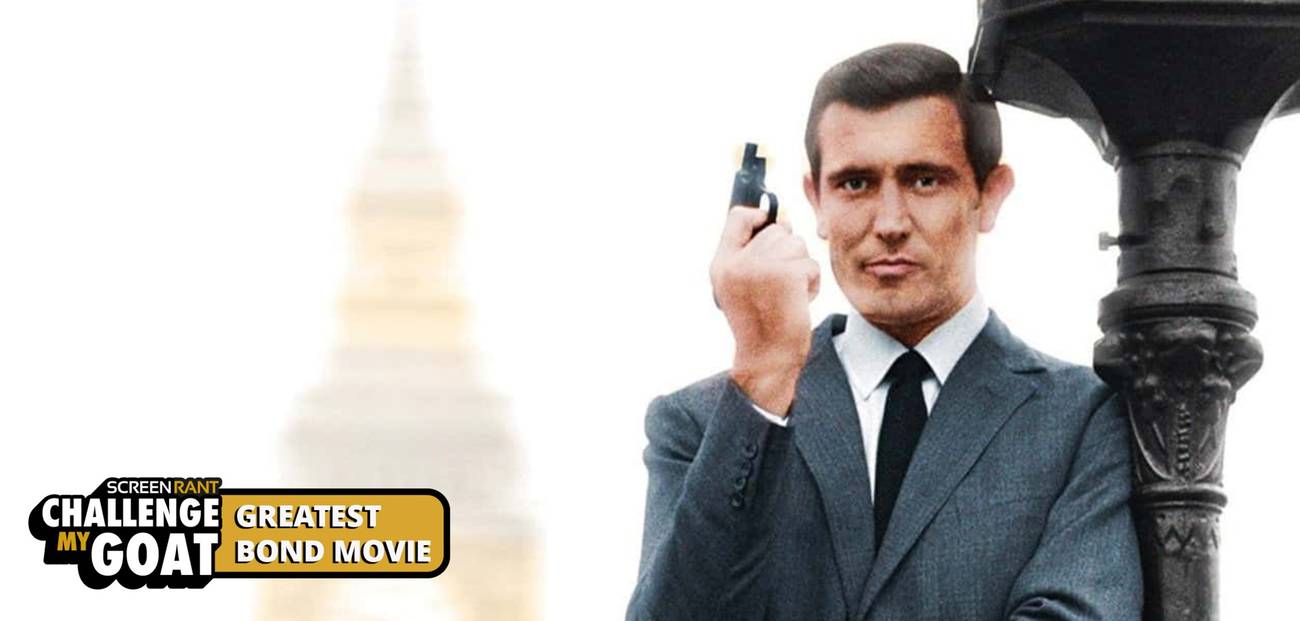 George Lazenby, as James Bond, leans against a lamppost holding a gun.