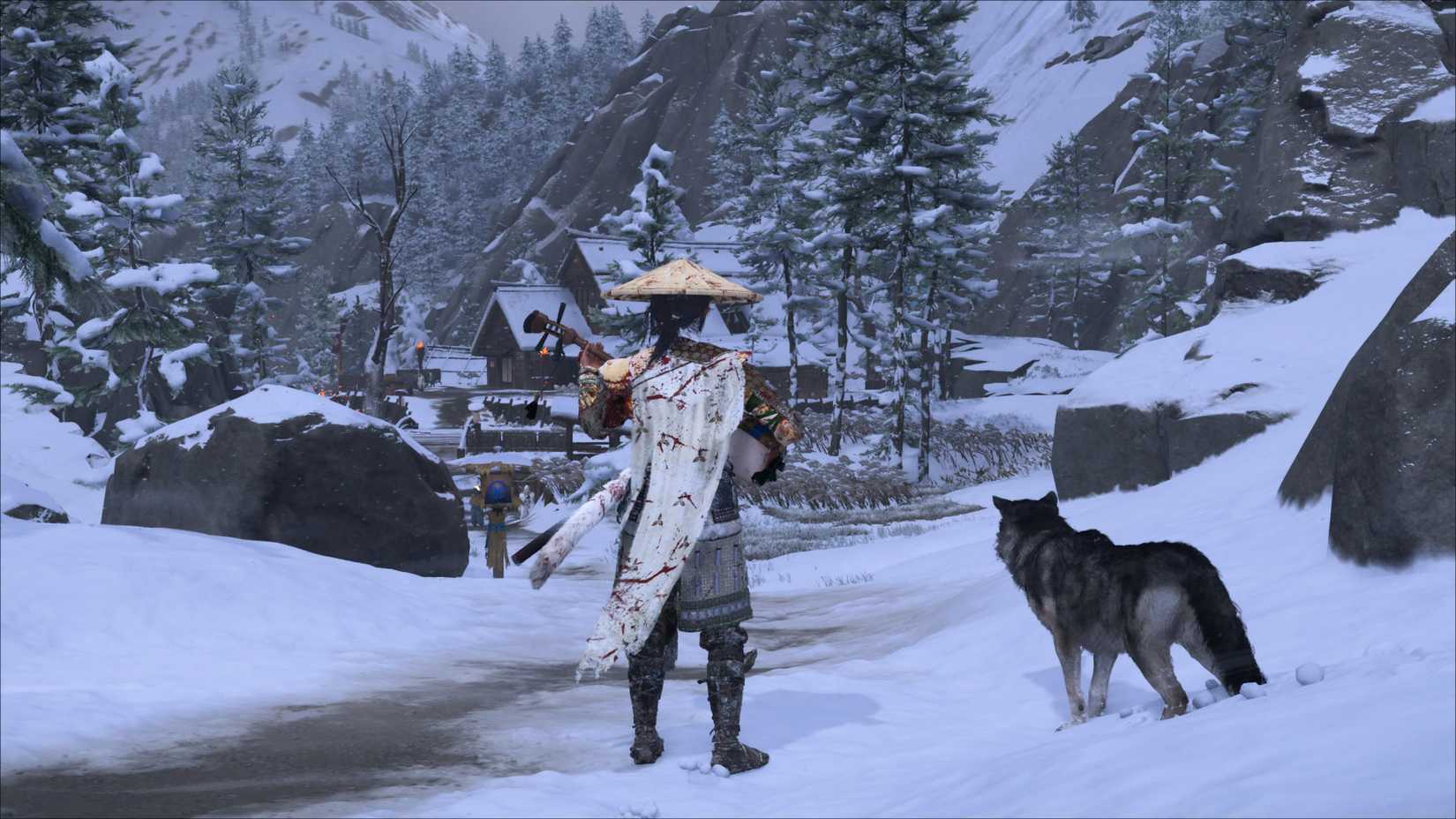 Atsu standing next to a wolf on a snowy path to a small village in Ghost of Yotei.