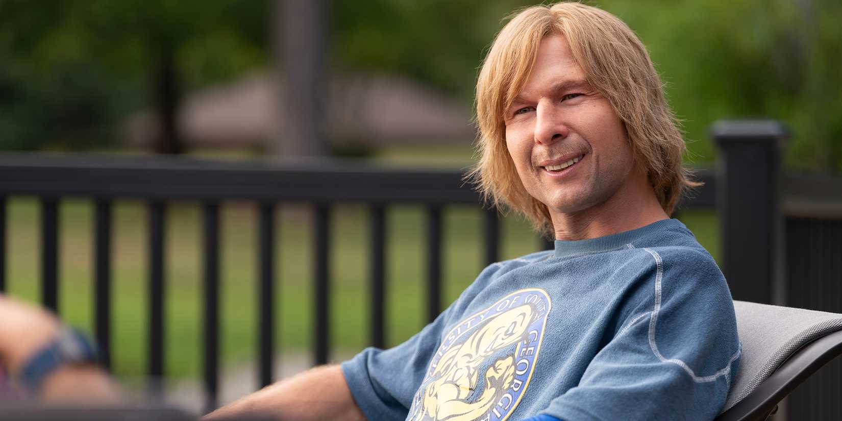 Glen Powell as Chad looking confused with a goofy look in Chad Powers