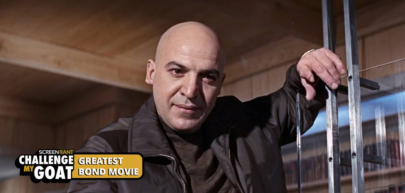 Telly Savalas, as Ernst Stavro Blofeld, leaning against a glᴀss door in On Her Majesty's Secret Service.
