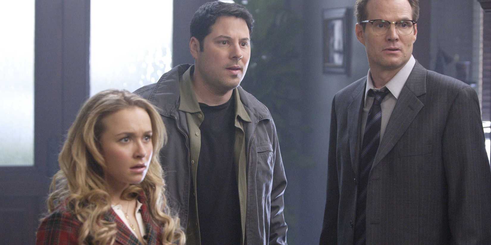 In Heroes, Hayden Panettiere as Claire Bennett, Greg Grunberg as Matt Parkman, and Jack Coleman as Noah Bennett stare off-screen in shock.