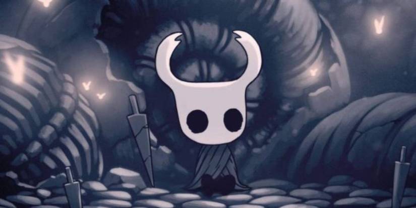 Hollow Knight main character leaning up against a wall with his weapon at his side.
