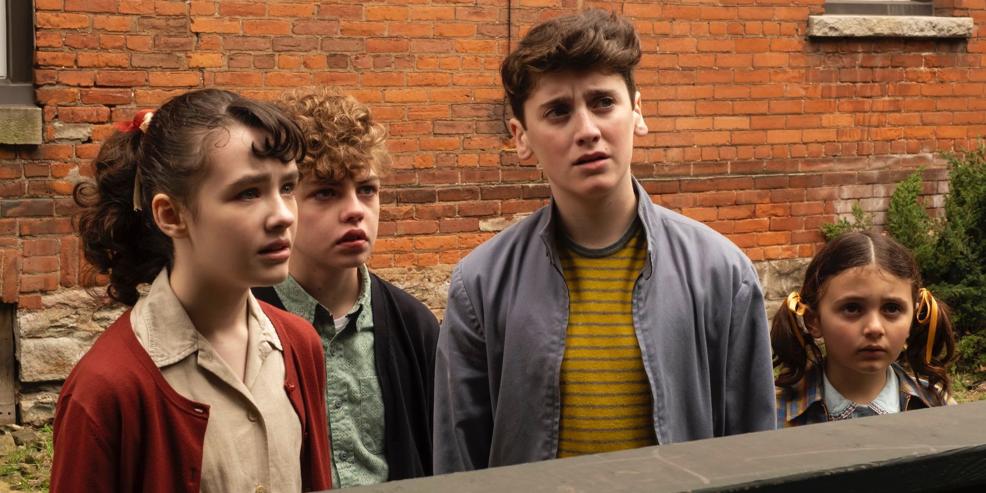 It: Welcome to Derry teens looking surprised at something off screen