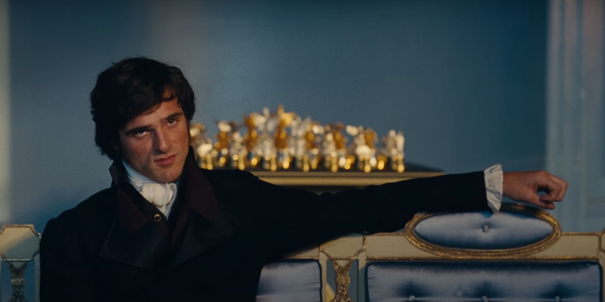 Jacob Elordi lounges on a couch as Heathcliff in Wuthering Heights