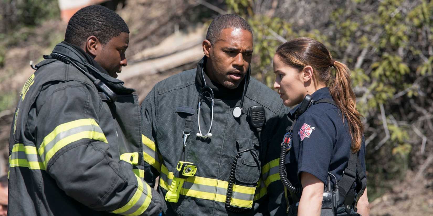 Jason George, Jaina Lee Ortiz, and Okieriete Onaodowan huddled together in firefighter uniforms in Station 19