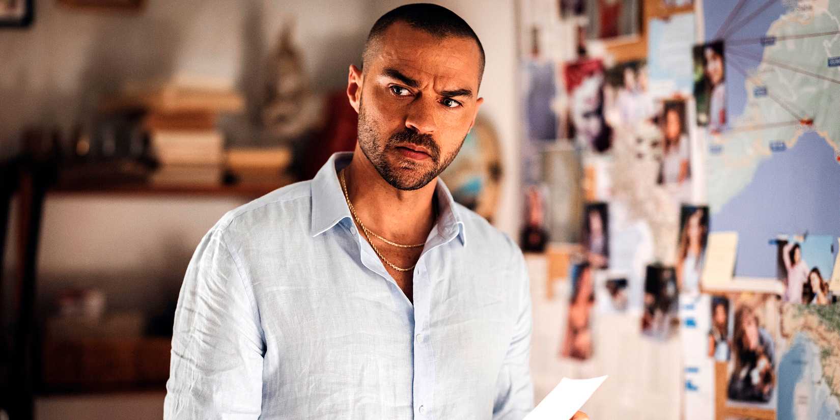 Jesse Williams as Daniel looking in thought near an evidence board in Hotel Costiera