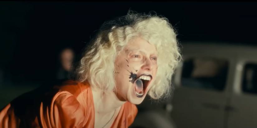 Jessie Buckley leaning forward and screaming in The Bride